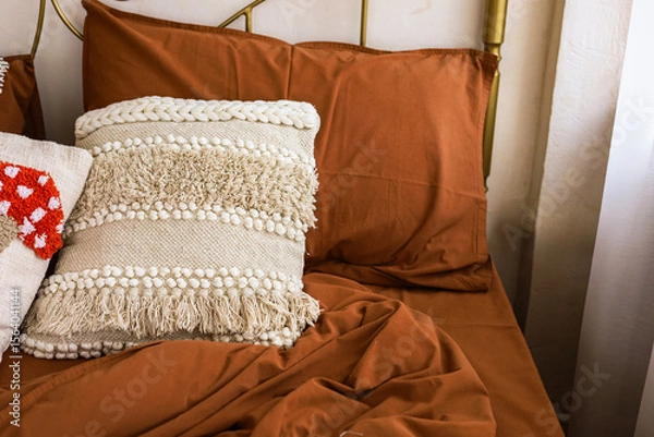 Obraz Decorated bed with cozy pillows and warm blankets in a tranquil bedroom setting