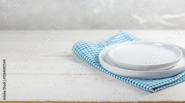Fototapeta Table setting. White plates on a white table. Copy space