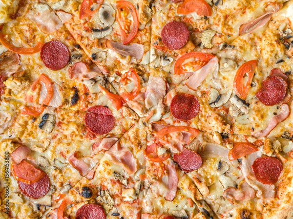 Fototapeta Meat Pizza with Bacon and Salami with Melted Cheese for Cooking