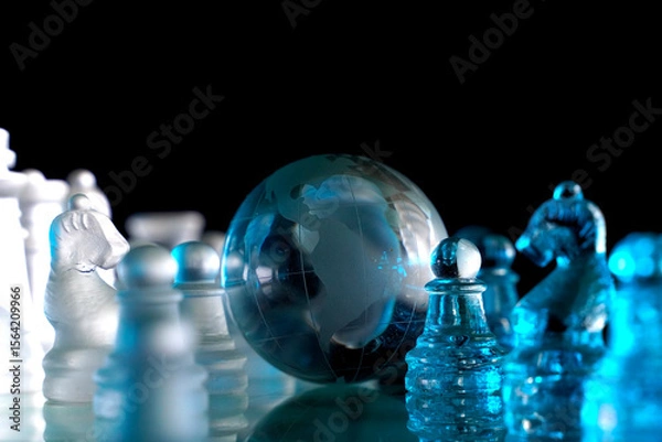 Fototapeta Crystal planet Earth amidst chess pieces showing the American continent, representing concepts of geopolitics, global power, competition for control, international relations, world leaders, struggle f