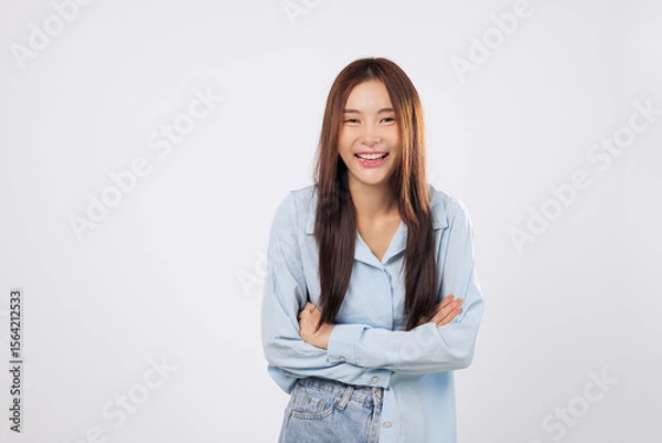 Fototapeta Confident smile from asian woman with crossed arms, a portrait of strength and poise, arms crossed in a powerful yet positive pose. isolated white background