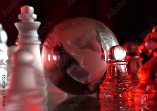 Fototapeta Crystal planet Earth amidst chess pieces showing the American continent, representing concepts of geopolitics, global power, competition for control, international relations, world leaders, struggle f