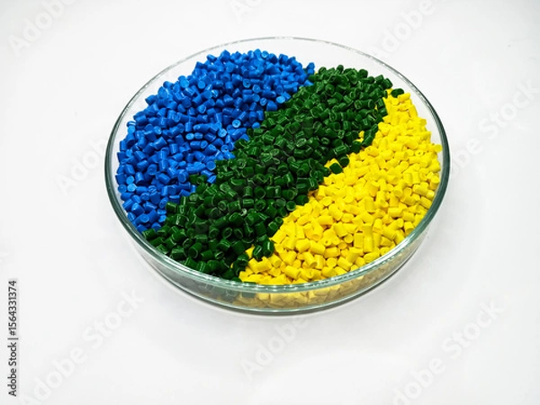 Fototapeta various colors of masterbatch granules in glass containers, polymer carrying resin and pigments poured in white background, suitable for product catalog design of industrial plastic company profile