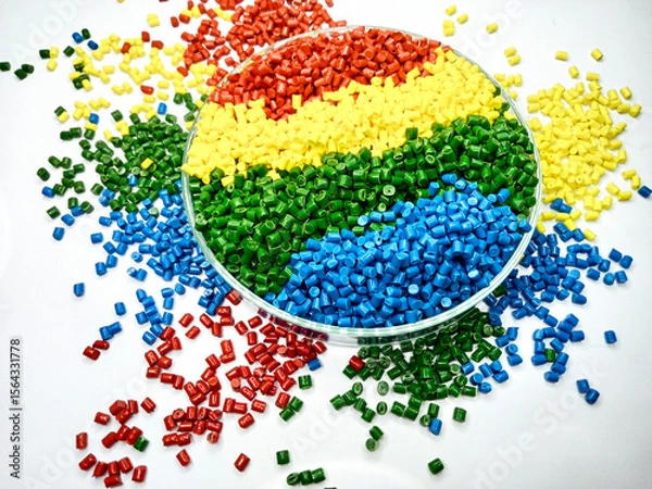 Fototapeta various colors of masterbatch granules in glass containers, polymer carrying resin and pigments poured in white background, suitable for product catalog design of industrial plastic company profile