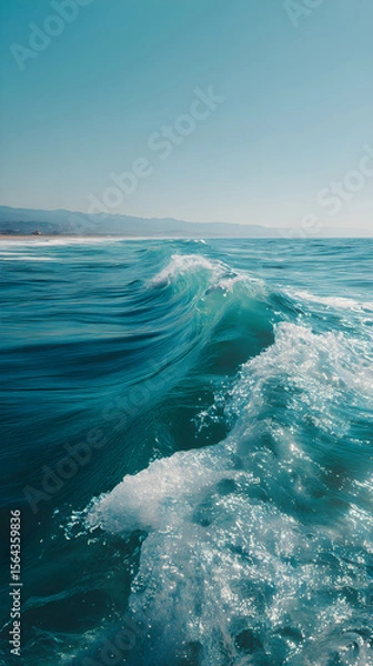 Fototapeta Infinite Turquoise: Capturing the Mesmerizing Dance of Ocean Waves Under Azure Skies with Shimmering Sunlit Crests