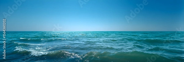 Fototapeta Infinite Turquoise: Capturing the Mesmerizing Dance of Ocean Waves Under Azure Skies with Shimmering Sunlit Crests