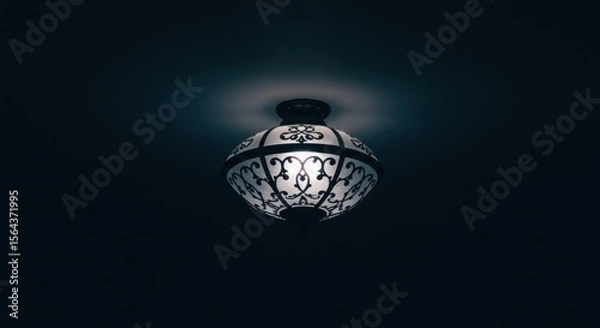 Fototapeta Elegant vintage ceiling lamp illuminating a dark room, creating a warm and inviting atmosphere