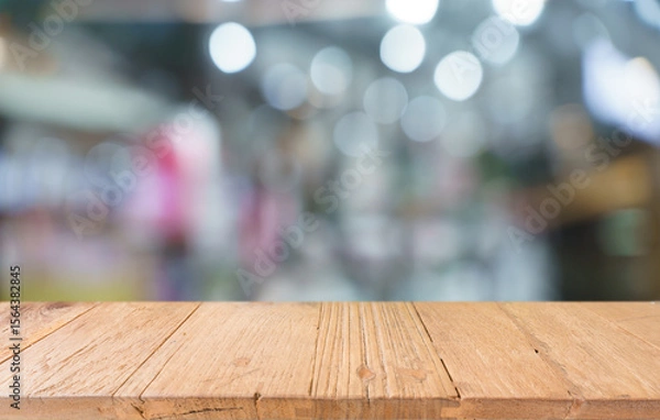 Fototapeta Empty wood table top and blur of restaurant background selective focus product display