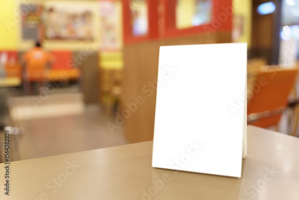 Fototapeta Menu mock up blank for text marketing promotion. Mock up Menu frame standing on wood table in restaurant space for text