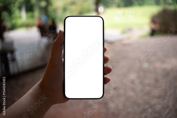 Fototapeta Smart phone mockup. Women hands holding cell telephone blank copy space screen smartphone blank white screen isolated technology concept.