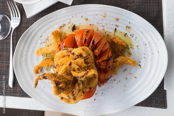 Obraz Crispy delicious fried squids served in a local restaurant in coastal village on Tenerife, Canary Islands, Spain