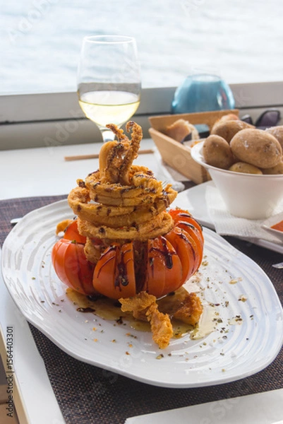 Obraz Crispy delicious fried squids served in a local restaurant in coastal village on Tenerife, Canary Islands, Spain