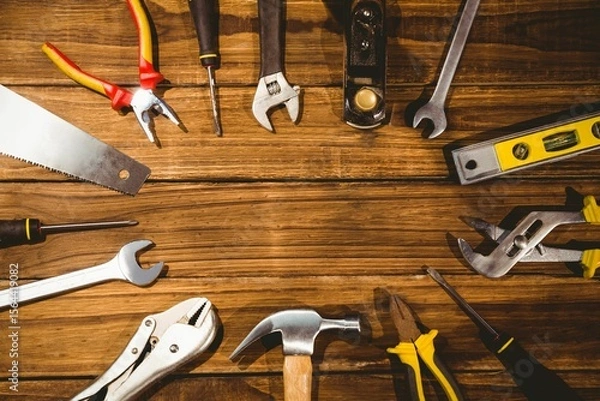 Fototapeta hand tools are being shown in flat design on wooden workbench with hammer, pliers, copy space