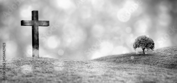 Fototapeta grayscale illustration is depicting wooden cross on misty grassy hill, with solitary tree and bokeh