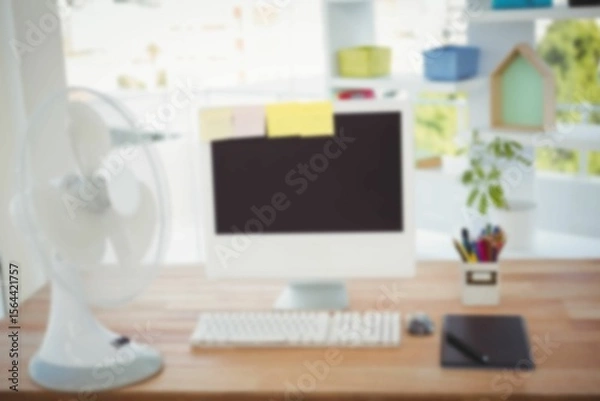 Obraz Electric table fan by computer on desk