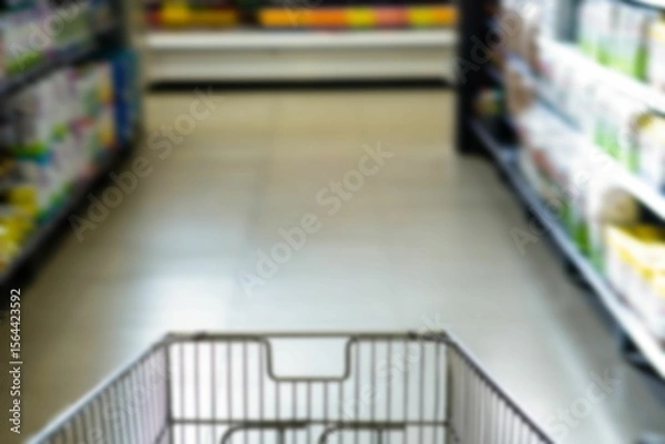 Obraz Shopping cart on aisle at supermarket