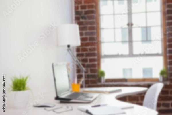 Obraz Defocused image of laptop on desk in office