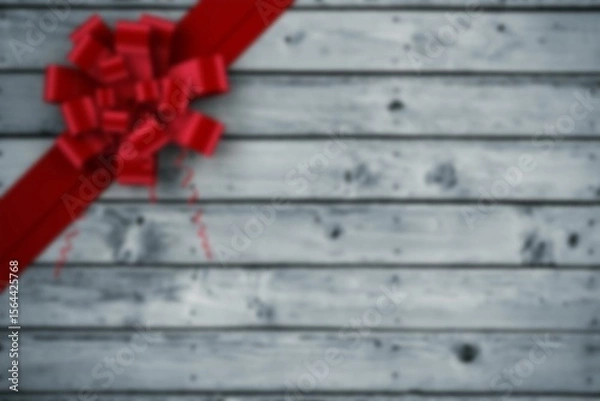 Fototapeta Bright red curled ribbon and bow are being shown on weathered gray wooden planks, flat design