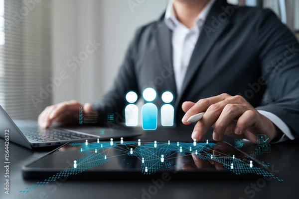 Fototapeta Digital transformation in human resource management. Businessman using smart technology and data networks to optimize workforce operations and enhance employee engagement in a modern workplace.