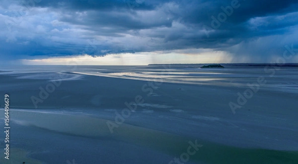 Fototapeta Dramatic tidal zone panorama with rain approaching on the horizon during early evening light