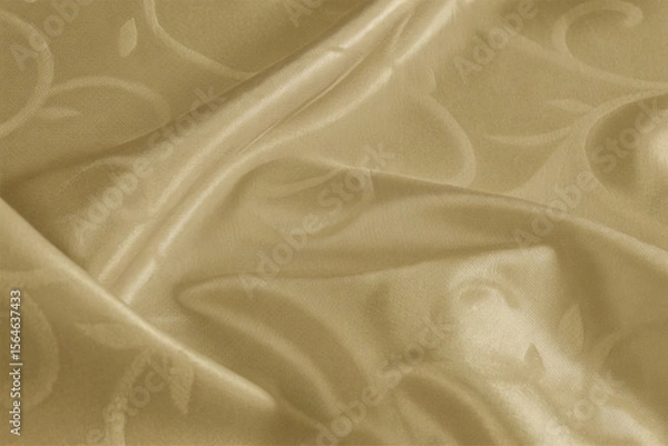 Fototapeta Smooth, elegant golden silk fabric with a flowing, shiny texture creates a luxurious backdrop