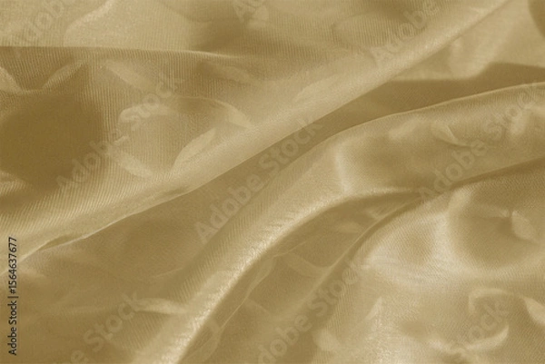 Fototapeta Smooth, elegant golden silk fabric with a flowing, shiny texture creates a luxurious backdrop
