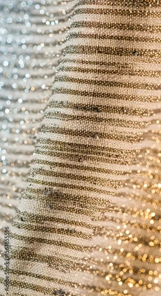 Fototapeta Elegant fabric detail showcases a textured, patterned surface with subtle shimmering stripes, suitable for various design projects.