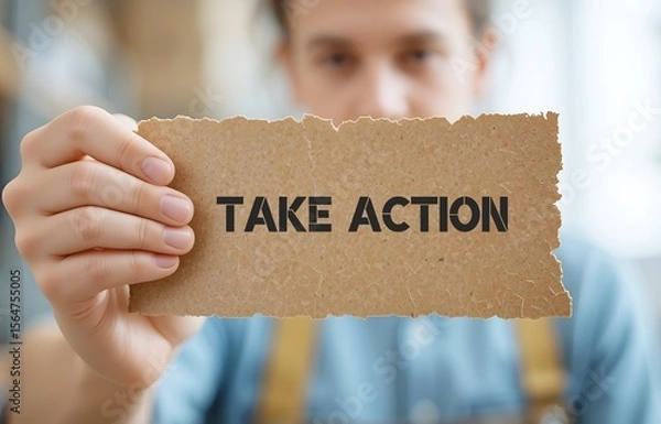 Fototapeta Employee holding cardboard paper written Take Action - to do something now or to act in order to get a particular result, no more procrastination