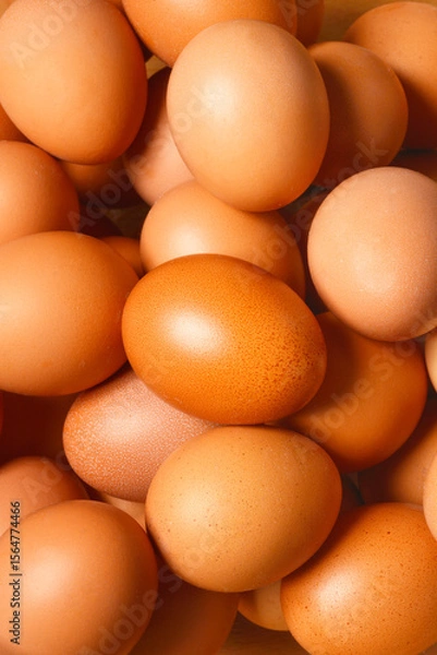 Obraz A close-up shot of a multitude of brown chicken eggs, filling the entire frame