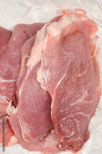 Obraz Fresh pieces of raw pork laid out on butcher paper