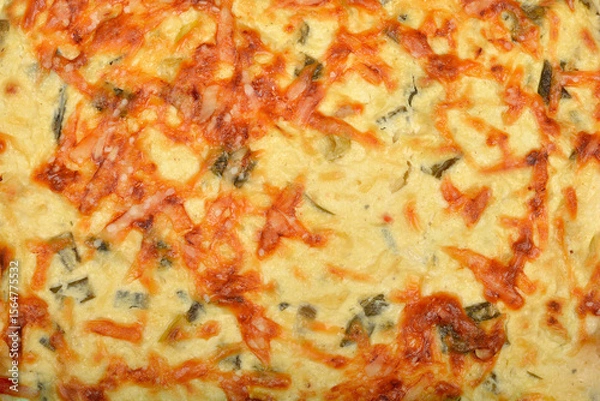 Obraz A close-up shot shows the golden-brown surface of a baked cheese and green onion pie