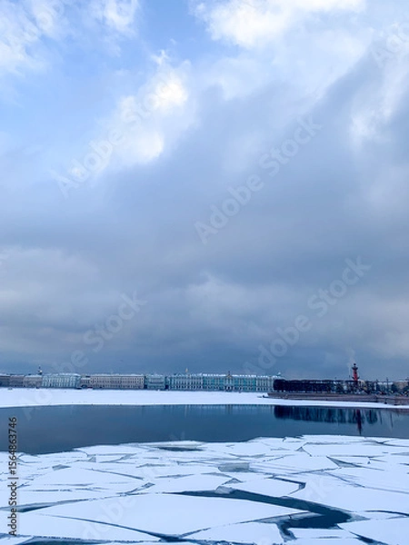 Fototapeta Frozen lake with fragmented ice under a brooding sky, evoking Winter Solstice introspection and serene Nordic mystery