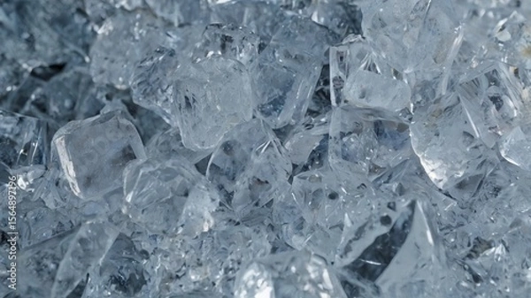 Fototapeta Ice, frozen, cold, transparent, clear – a close-up view of crushed ice pieces, glistening with light, showing sharp texture and natural beauty, ideal for cooling drinks, food styling, or backgrounds.
