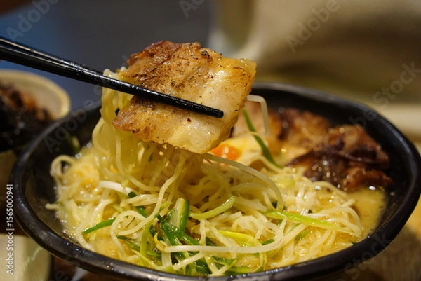 Obraz Close-up of Japanese Ramen Noodles with Pork Belly Lifted by Chopsticks