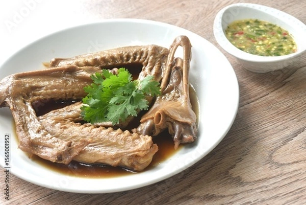 Obraz chop boiled duck wing and beak with tongue stew in brown soy soup on plate dipping spicy sour chili sauce 