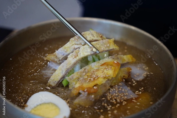 Obraz Close-up of Korean Naengmyeon Cold Noodles Topped with Sliced Beef Pancake (Yukjeon)