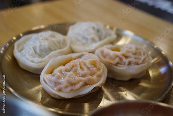 Obraz Close-up of Juicy Steamed Kimchi and Meat Dumplings on a Plate in a Korean Restaurant