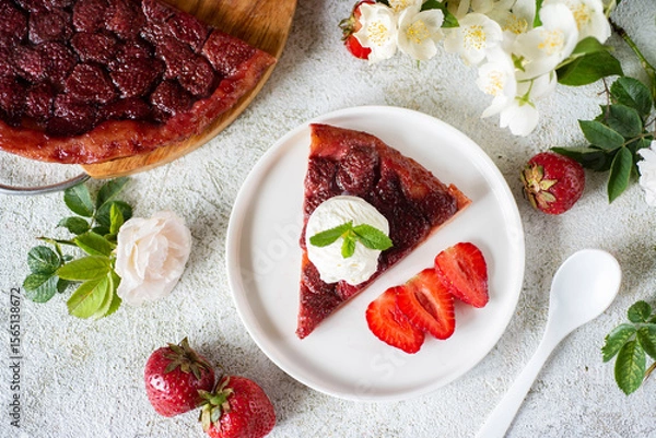 Fototapeta Strawberry pie for dessert. A slice of strawberry pie on a white plate for breakfast. A slice of berry pie on a white plate on a light background. Close-up