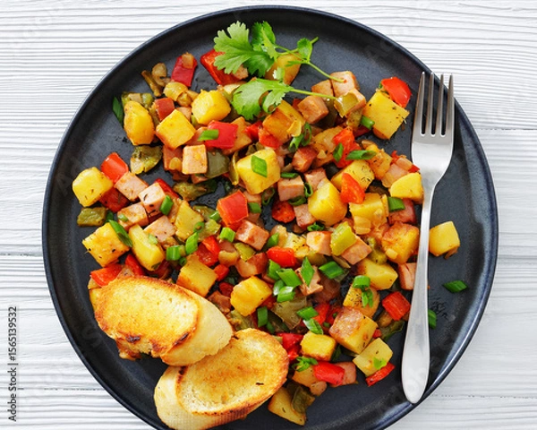Fototapeta crispy fried cubed potatoes with ham, bell peppers