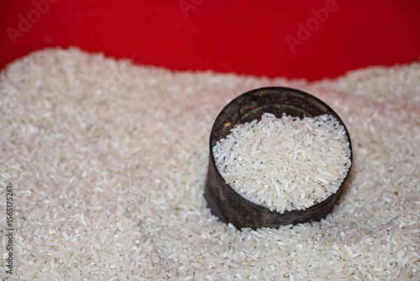 Fototapeta A measuring tin half buried in a pile of white rice