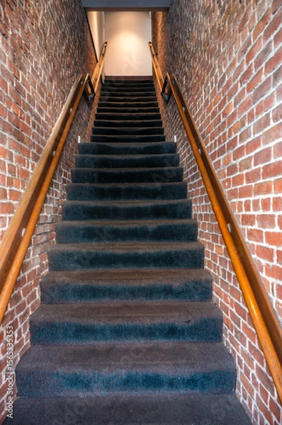 Fototapeta Mysterious Staircase Built Between Two Red Brick Buildings in Honolulu Chinatown.