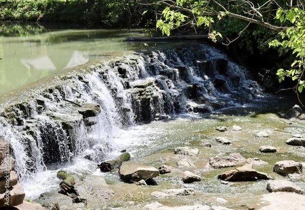 Fototapeta The waterfall in the park on a sunny day