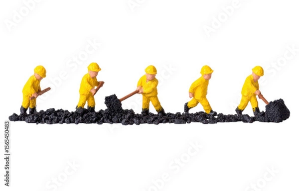 Fototapeta Miniature construction workers in yellow uniforms performing excavation on black soil in a playful and creative layout