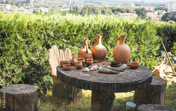 Fototapeta Georgia equipment set isolated on white background. Vector illustration of Georgian flag, grapes, bottles and glass with wine, jug, dagger, wine horn, pandura, hat in cartoon style.