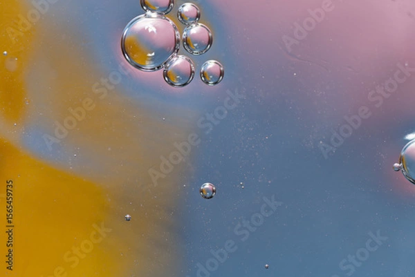 Fototapeta abstract background water droplets, ring and crystal shapes reflecting pink, orange and blue wet surface, copy space
