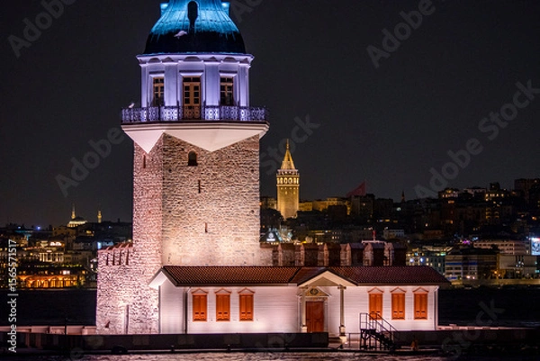 Fototapeta A night view of the famous Maiden's Tower, also known as Leander's Tower, a symbol of Istanbul, over the Bosphorus. Scenic travel background for wallpaper or guidebook. Istab