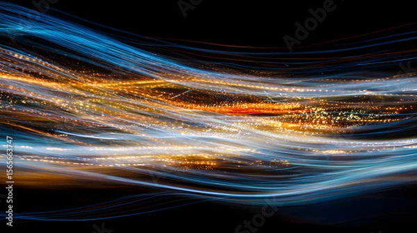 Fototapeta Abstract light trails in blue and orange hues creating a dynamic, flowing pattern against a dark background, suggesting data or energy movement.