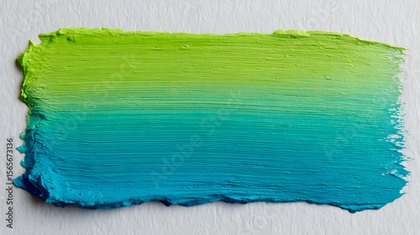 Fototapeta A textured brushstroke transitioning from vibrant lime green to deep turquoise blue on a white background.