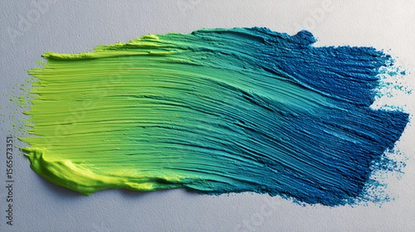 Fototapeta Textured paint swatch showing a vibrant gradient from lime green to deep teal blue with visible brushstrokes on a light background.