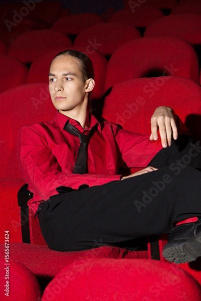 Obraz young man sitting on a sofa